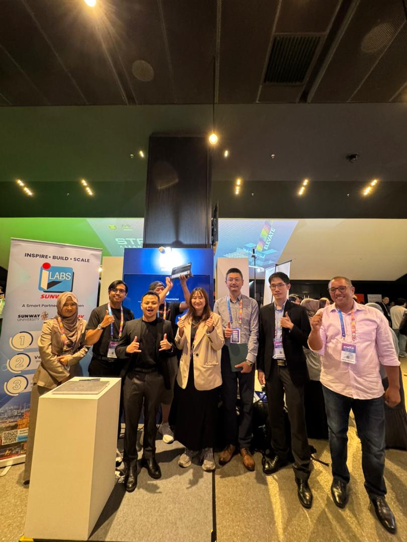 Cohort celebrating at the booth